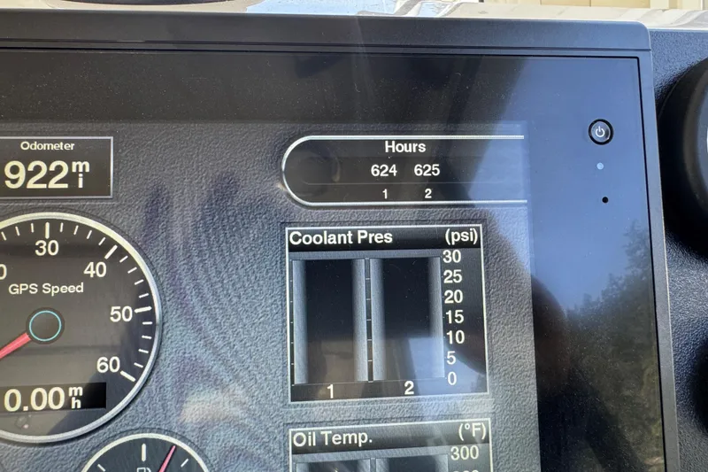 Slide: The Image of Dashboard of a 2010 Ocean Sport Roamer showing odometer, hours, coolant pressure, and oil temperature. - 10