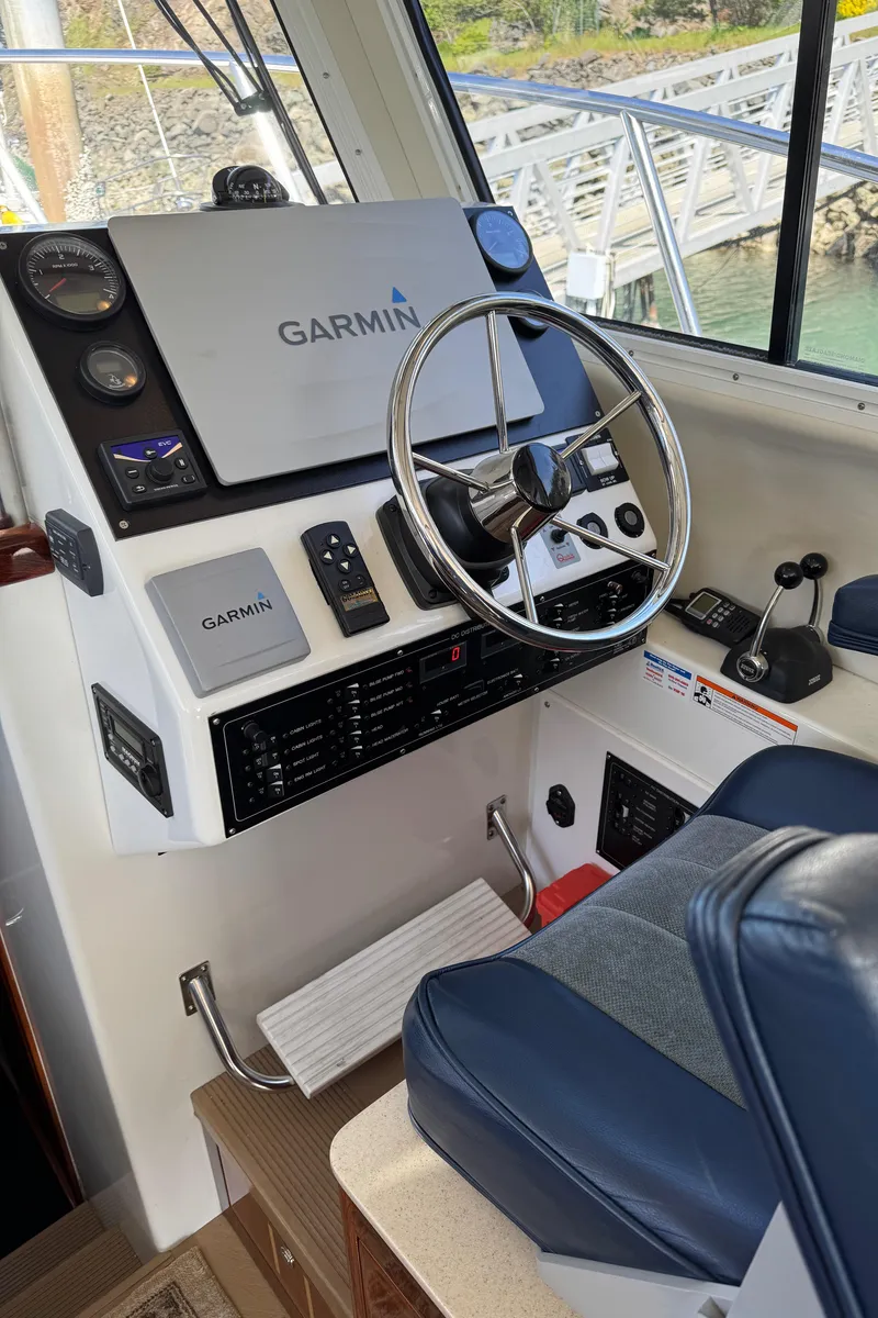 Slide: The Image of 2010 Ocean Sport Roamer boat cockpit with Garmin navigation system and steering wheel. - 11