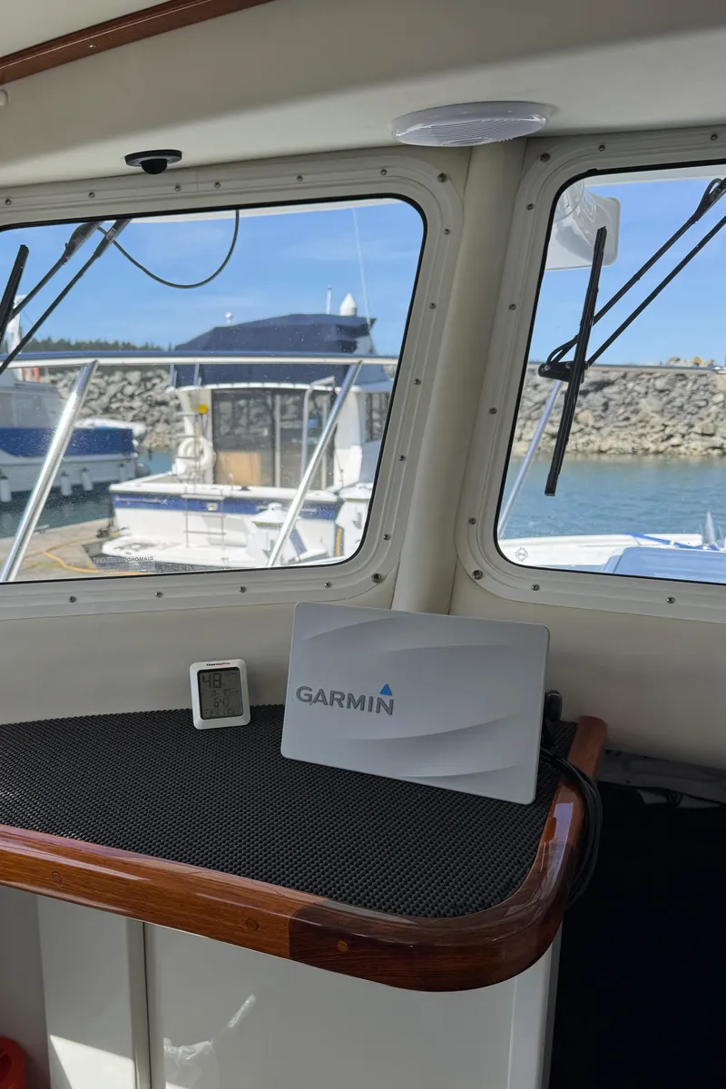 Slide: The Image of 2010 Ocean Sport Roamer interior with Garmin navigation system, docked at marina. - 13