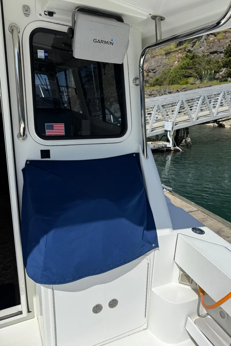 Slide: The Image of 2010 Ocean Sport Roamer boat interior with Garmin equipment and dock view. - 19