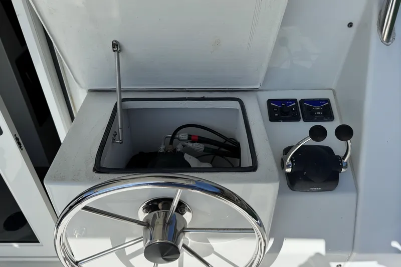 Slide: The Image of Steering wheel and controls of a 2010 Ocean Sport Roamer boat. - 21