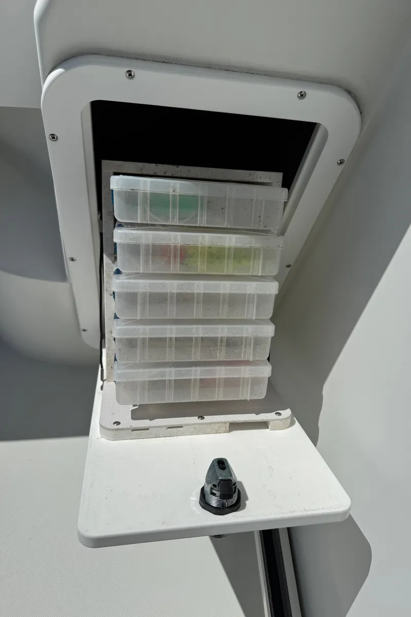 Slide: The Image of Storage compartment with tackle boxes on a 2010 Ocean Sport Roamer boat. - 22