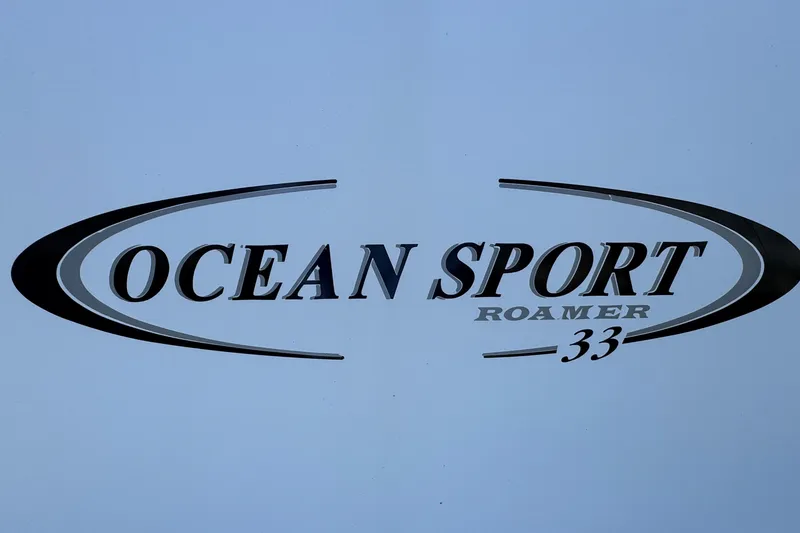 Slide: The Image of Ocean Sport Roamer 33 logo, 2010 model, sleek design on a light background. - 23