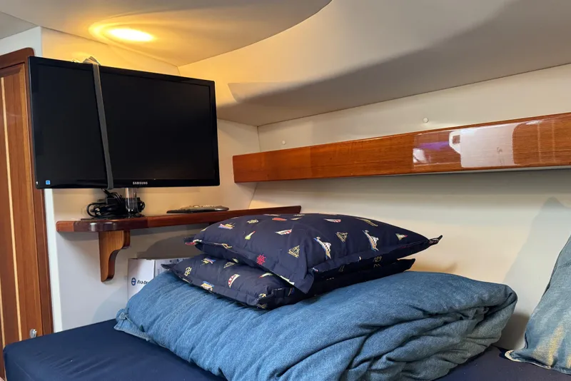 Slide: The Image of Cozy cabin interior of 2010 Ocean Sport Roamer with TV and bedding. - 24