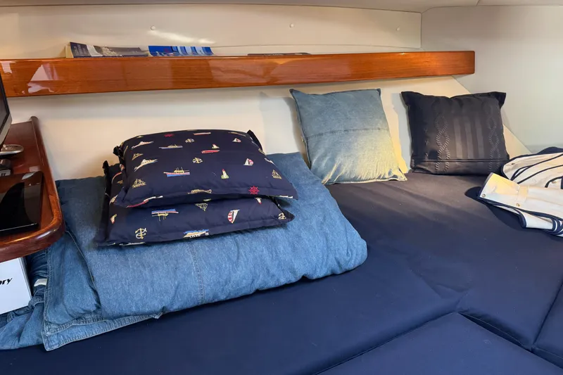 Slide: The Image of Cozy cabin interior of 2010 Ocean Sport Roamer with pillows and wooden shelf. - 25