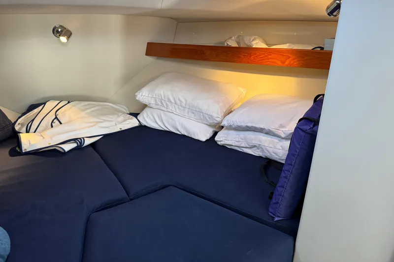 Slide: The Image of Cozy cabin interior of 2010 Ocean Sport Roamer with blue bedding and pillows. - 26