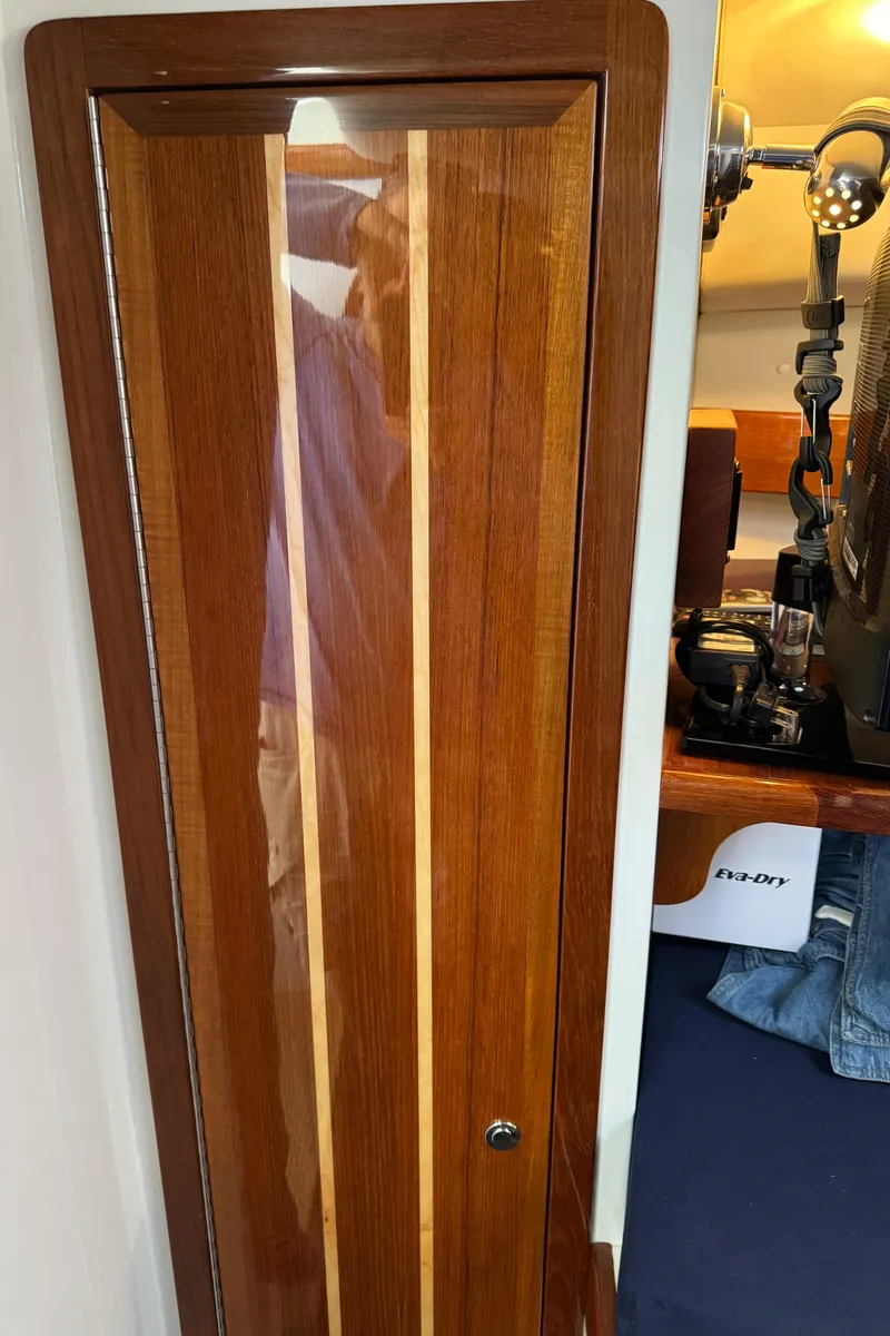 Slide: The Image of Wooden cabinet door inside 2010 Ocean Sport Roamer boat interior. - 27
