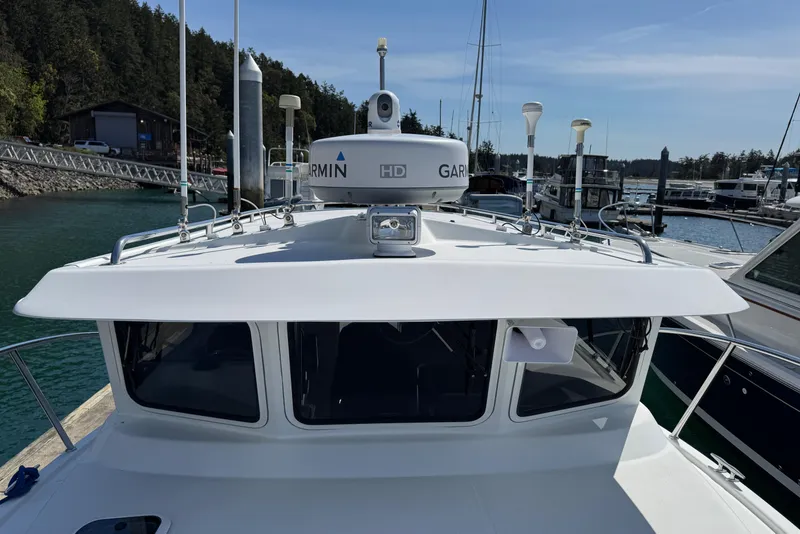 Slide: The Image of 2010 Ocean Sport Roamer boat docked at a marina with Garmin equipment. - 3