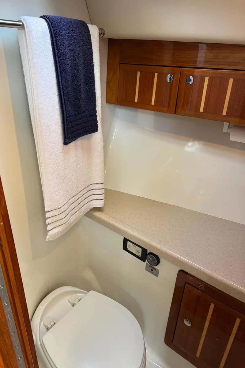 Slide: The Image of 2010 Ocean Sport Roamer bathroom with wooden cabinets and towel rack. - 30