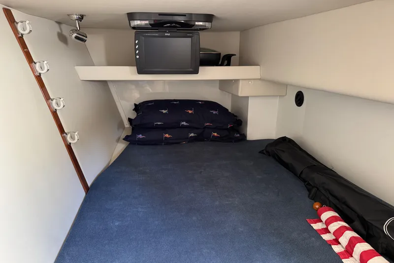 Slide: The Image of 2010 Ocean Sport Roamer cabin with bed, TV, and nautical decor. - 36