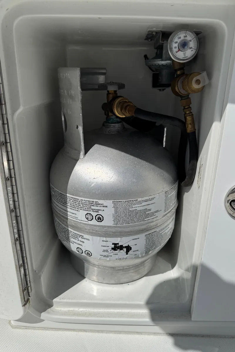 Slide: The Image of Propane tank in Ocean Sport Roamer 2010 storage compartment with gauge and valve. - 37
