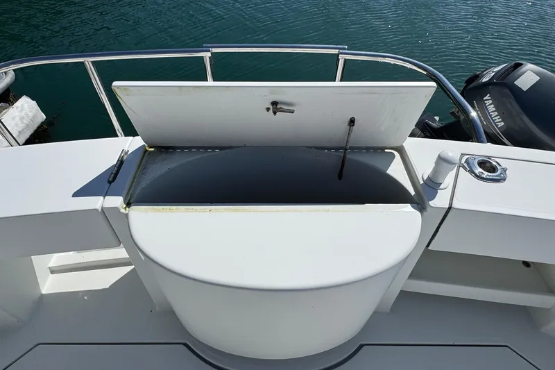 Slide: The Image of 2010 Ocean Sport Roamer boat with open storage compartment on deck. - 38