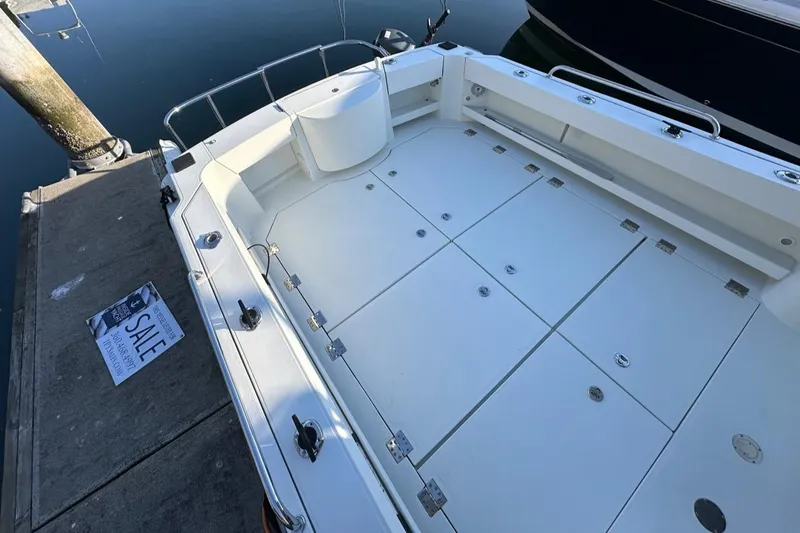 Slide: The Image of 2010 Ocean Sport Roamer boat for sale, docked with spacious deck and clean design. - 42