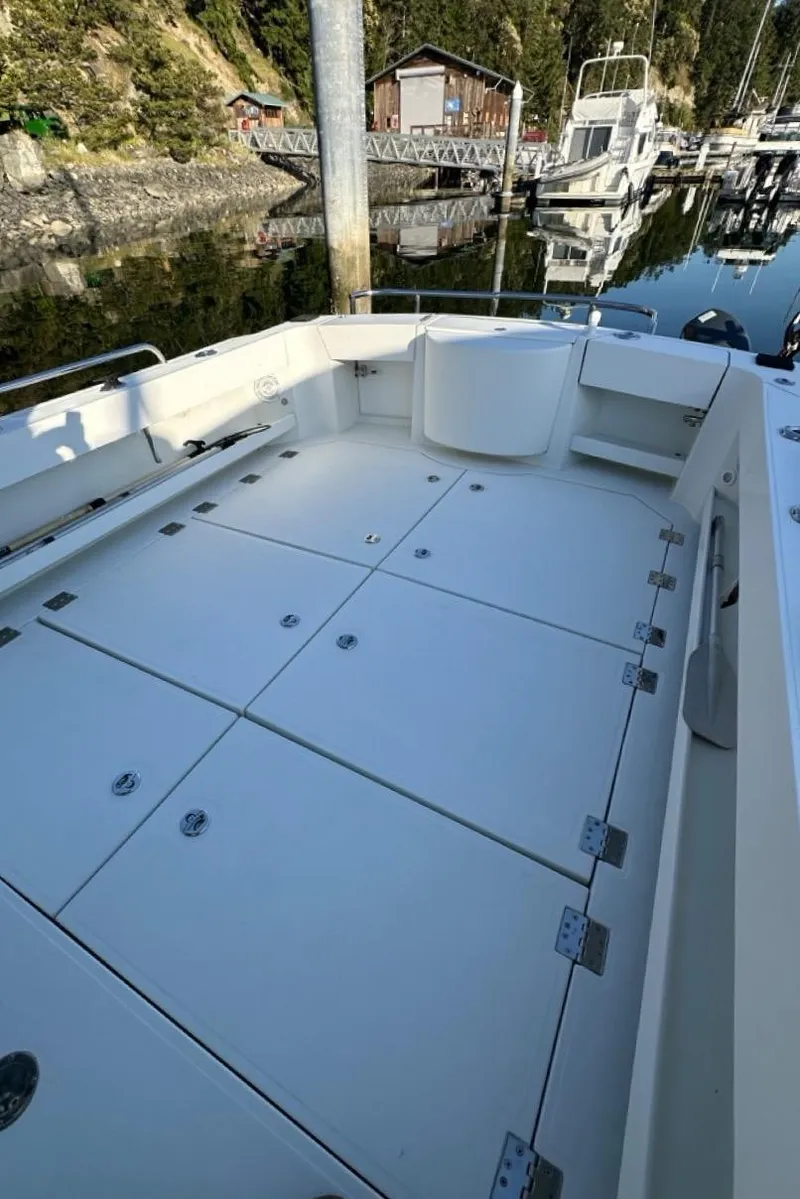 Slide: The Image of 2010 Ocean Sport Roamer boat with spacious deck at a marina. - 44