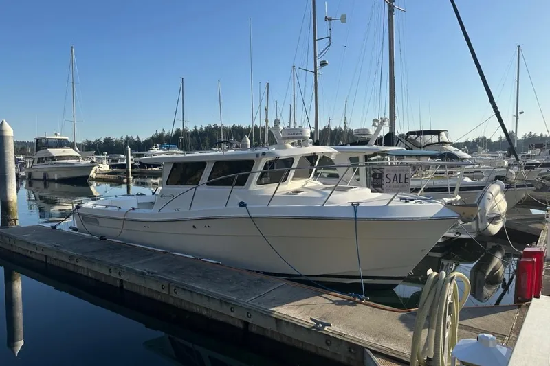 Slide: The Image of 2010 Ocean Sport Roamer boat docked at marina, surrounded by other vessels. - 48