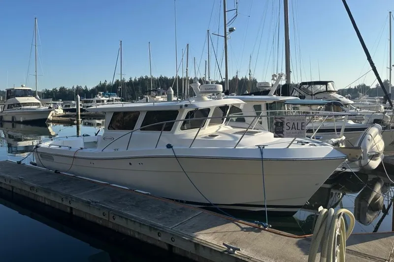 Slide: The Image of 2010 Ocean Sport Roamer boat docked at marina, surrounded by other vessels. - 49