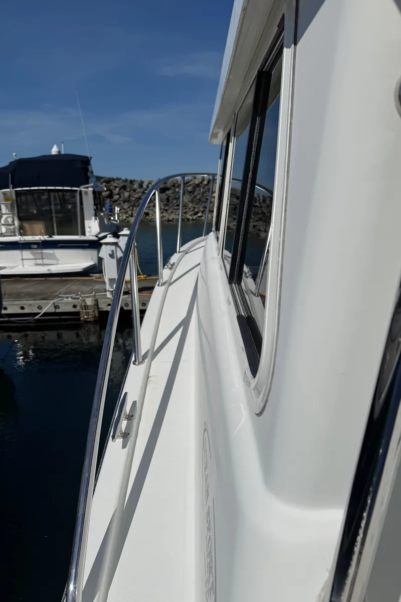 Slide: The Image of 2010 Ocean Sport Roamer boat docked at marina, side view with clear sky. - 6