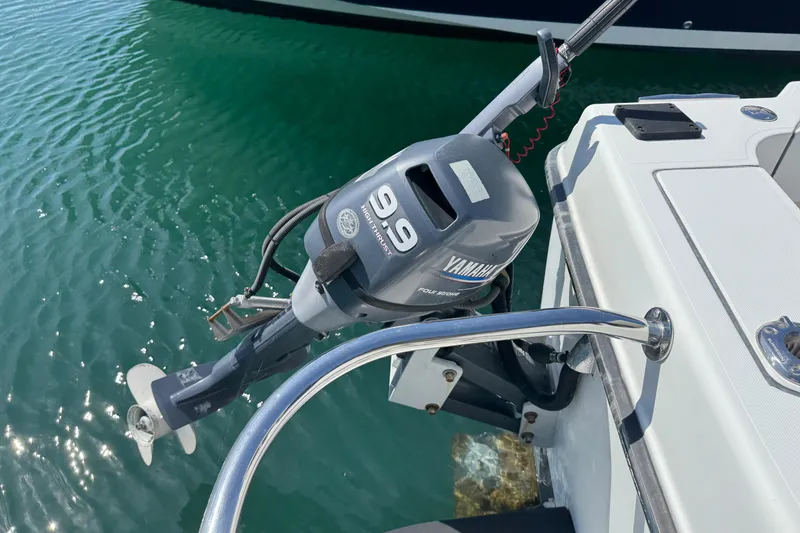 Slide: The Image of Outboard motor on 2010 Ocean Sport Roamer boat, Yamaha 9.9 horsepower, in clear water. - 7