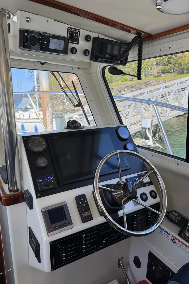 Slide: The Image of 2010 Ocean Sport Roamer boat cockpit with steering wheel and navigation equipment. - 8
