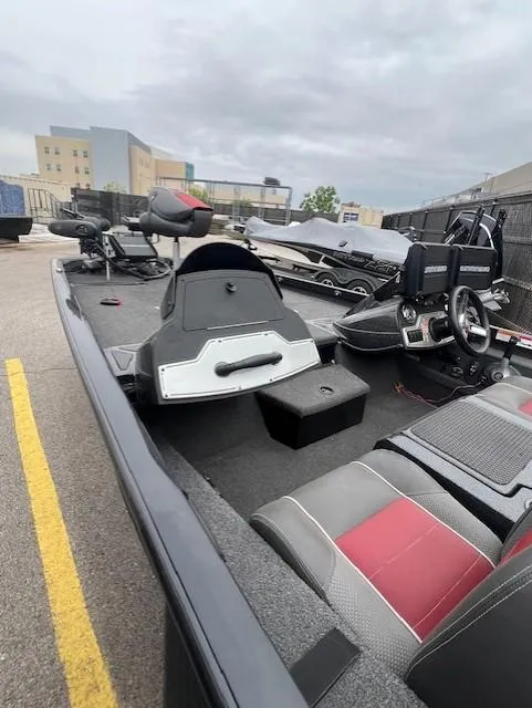 Slide: The Image of 2018 Ranger RT 198P fishing boat with seating and steering wheel, parked outdoors. - 8