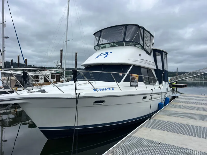The Image of 1999 Bayliner 4087 Aft Cabin Motoryacht cruising on a scenic lake. - 0