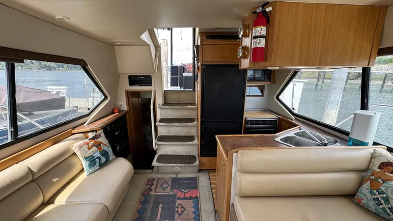 Slide: The Image of Interior of 1999 Bayliner 4087 Aft Cabin Motoryacht with seating, kitchen, and stairs. - 11