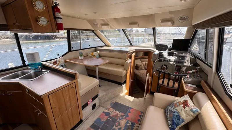 Slide: The Image of 1999 Bayliner 4087 Aft Cabin Motoryacht interior with helm, seating, and kitchenette. - 13