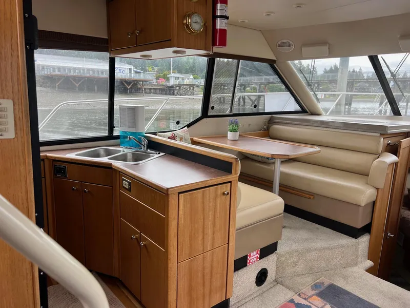 Slide: The Image of 1999 Bayliner 4087 Aft Cabin Motoryacht interior with kitchen and dining area. - 15