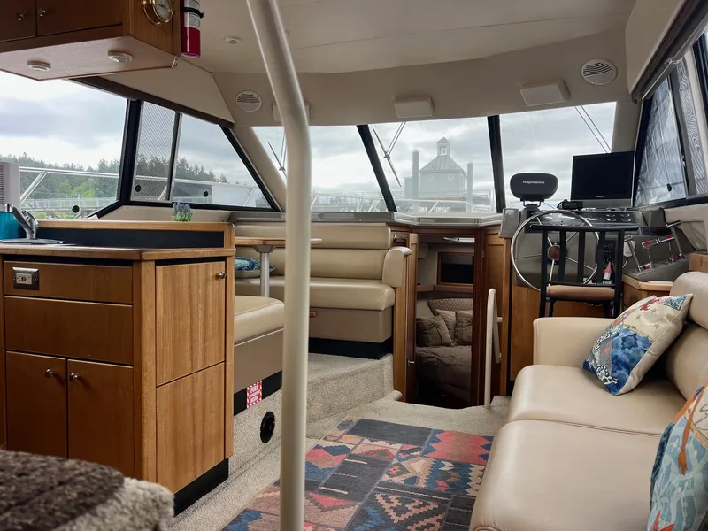 Slide: The Image of 1999 Bayliner 4087 Aft Cabin Motoryacht interior with cozy seating and modern navigation equipment. - 16