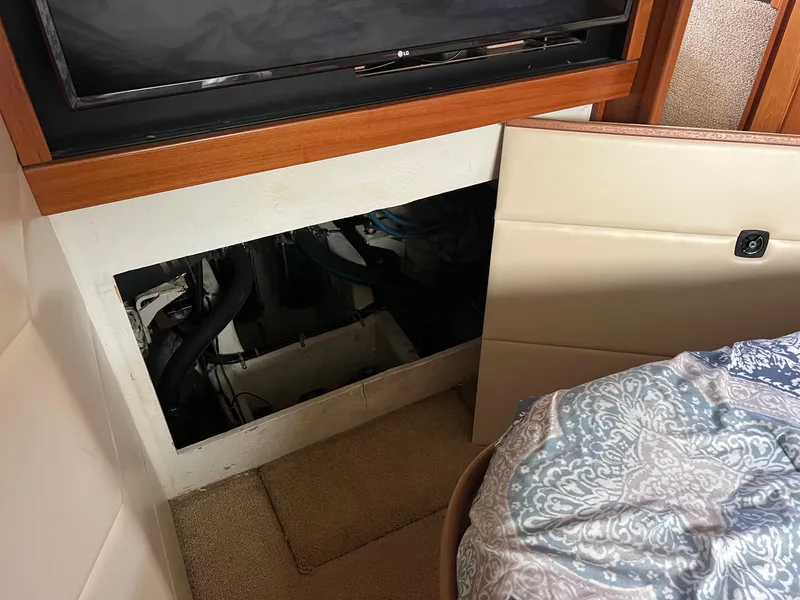 Slide: The Image of 1999 Bayliner 4087 Aft Cabin Motoryacht interior with open panel revealing engine compartment. - 17