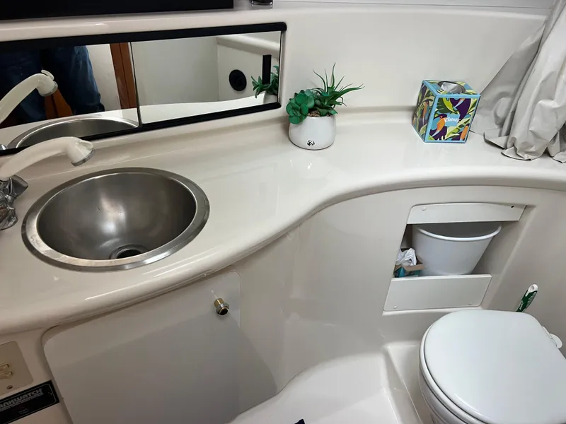 Slide: The Image of 1999 Bayliner 4087 Aft Cabin Motoryacht bathroom with sink, mirror, and toilet. - 25