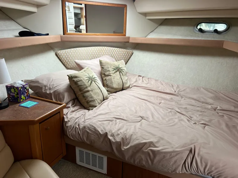 Slide: The Image of 1999 Bayliner 4087 Aft Cabin Motoryacht bedroom with cozy bedding and decorative pillows. - 28