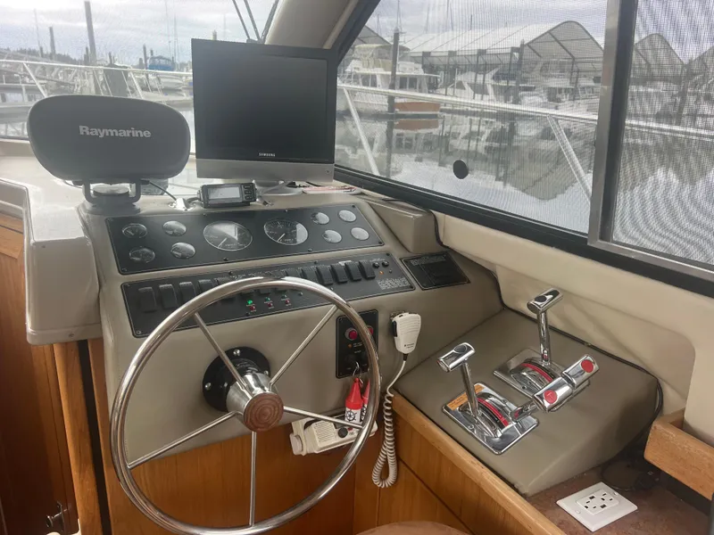 Slide: The Image of 1999 Bayliner 4087 Aft Cabin Motoryacht helm with steering wheel and navigation equipment. - 30