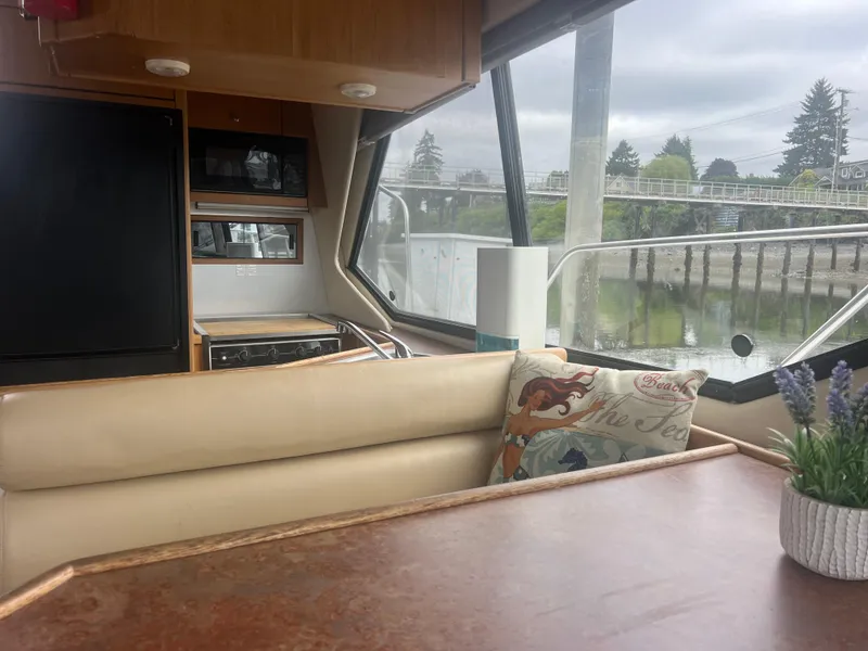 Slide: The Image of Interior of 1999 Bayliner 4087 Aft Cabin Motoryacht with seating, table, and kitchen area. - 31