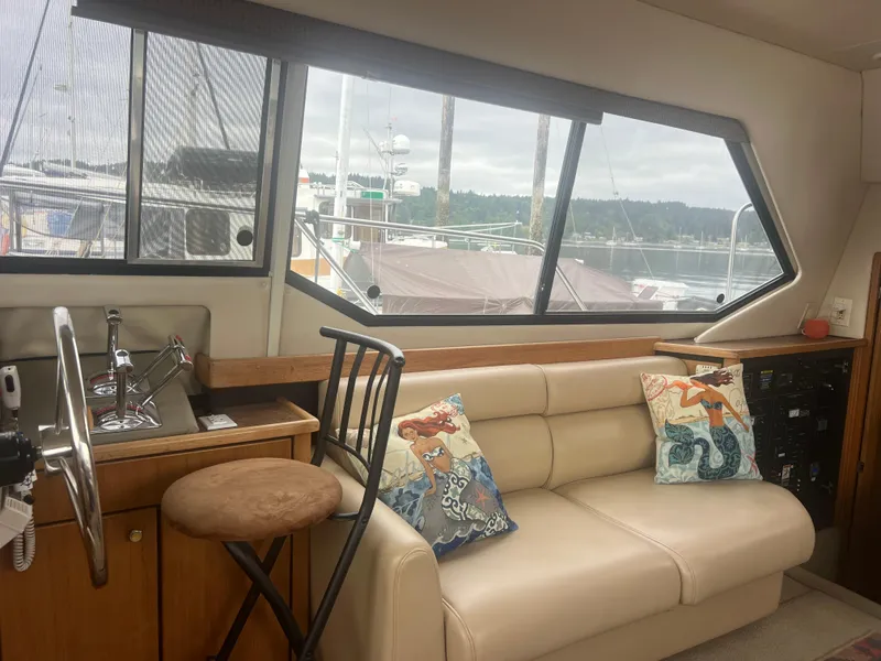 Slide: The Image of Interior of 1999 Bayliner 4087 Aft Cabin Motoryacht with sofa, helm, and scenic window view. - 32