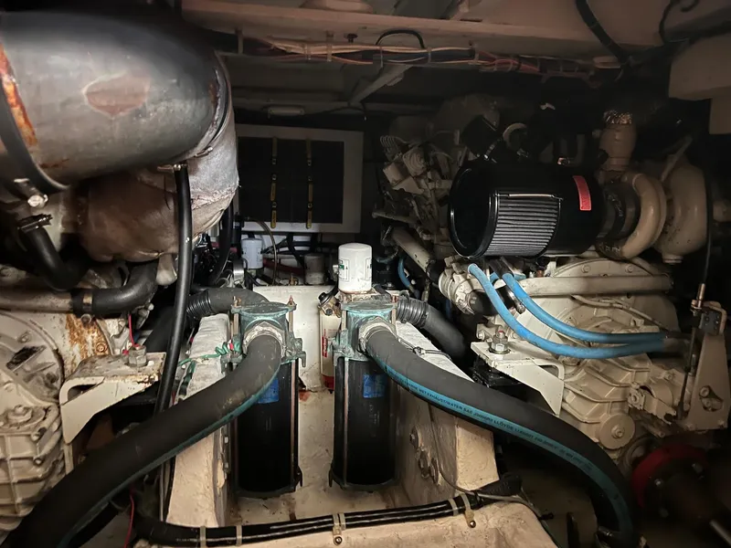 Slide: The Image of Engine room of 1999 Bayliner 4087 Aft Cabin Motoryacht with visible components and hoses. - 38