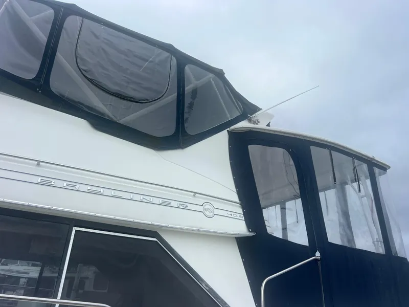 Slide: The Image of 1999 Bayliner 4087 Aft Cabin Motoryacht with enclosed upper deck and sleek design. - 9