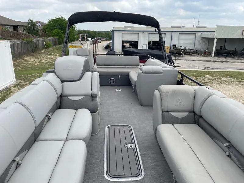 Slide: The Image of 2022 Regency 250 DL3 pontoon boat with spacious seating and modern design. - 13