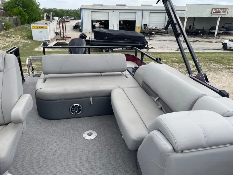 Slide: The Image of 2022 Regency 250 DL3 pontoon boat with gray seating and spacious deck area. - 14