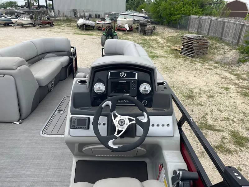 Slide: The Image of 2022 Regency 250 DL3 pontoon boat interior with steering console and seating. - 19