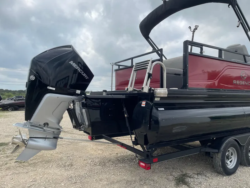 Slide: The Image of 2022 Regency 250 DL3 pontoon boat with Mercury outboard motor, on a trailer. - 4
