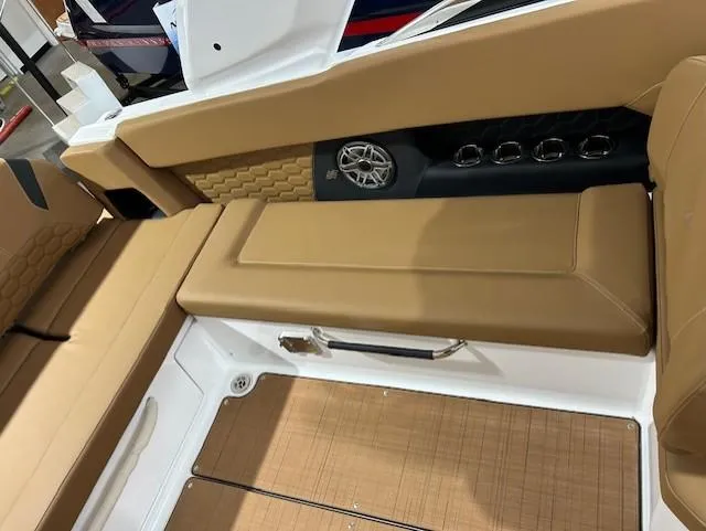 Slide: The Image of 2025 Four Winns H9 OB boat interior with tan seating and speaker system. - 10