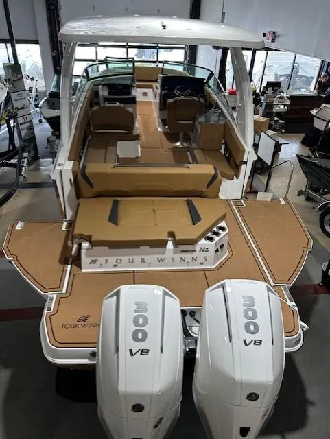 Slide: The Image of 2025 Four Winns H9 OB boat with dual 300 V8 engines, spacious deck, and modern design. - 2