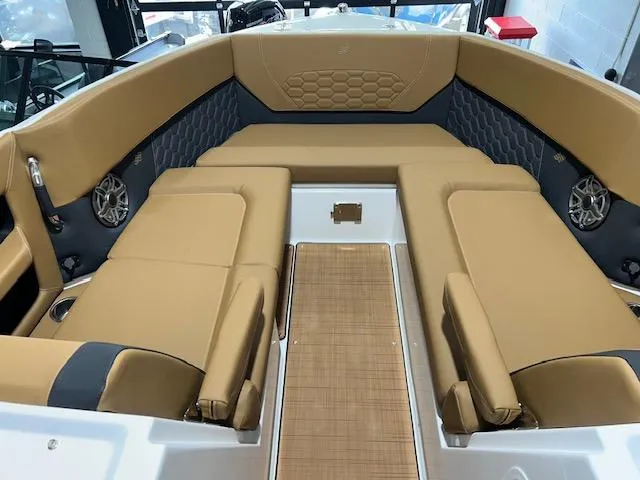 Slide: The Image of 2025 Four Winns H9 OB boat interior with tan seating and modern design. - 4