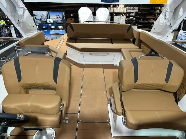 Slide: The Image of 2025 Four Winns H9 OB boat interior with tan seating and modern design. - 5