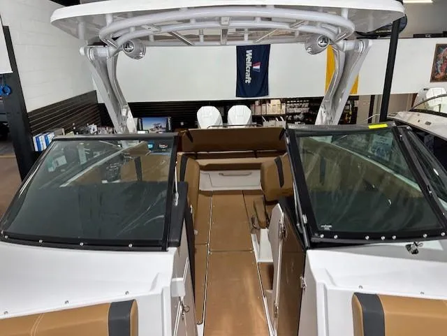 Slide: The Image of 2025 Four Winns H9 OB boat interior with brown seating and sleek design. - 6