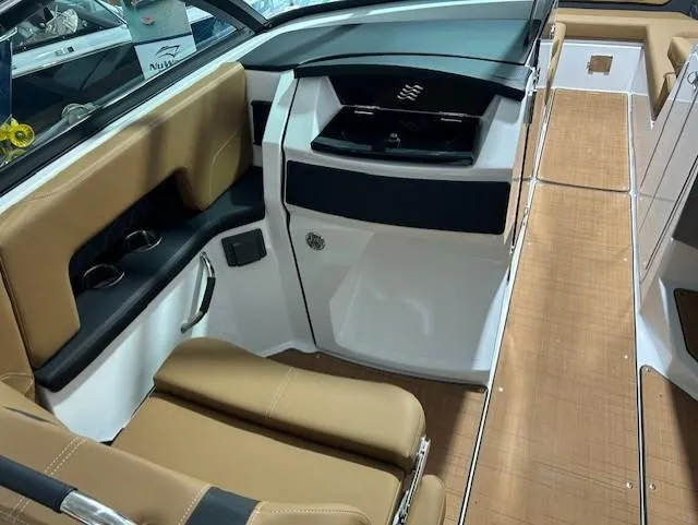 Slide: The Image of 2025 Four Winns H9 OB boat interior with tan seating and sleek design. - 9