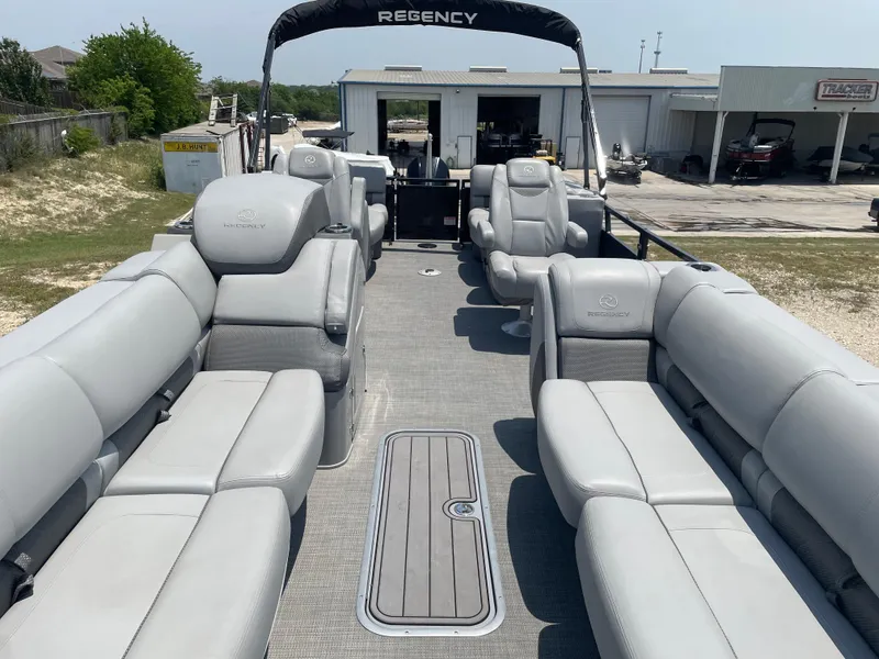 Slide: The Image of 2023 Regency 250 LE3 pontoon boat with spacious seating and modern design. - 13