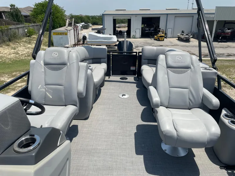 Slide: The Image of 2023 Regency 250 LE3 pontoon boat with luxurious seating and modern design. - 14