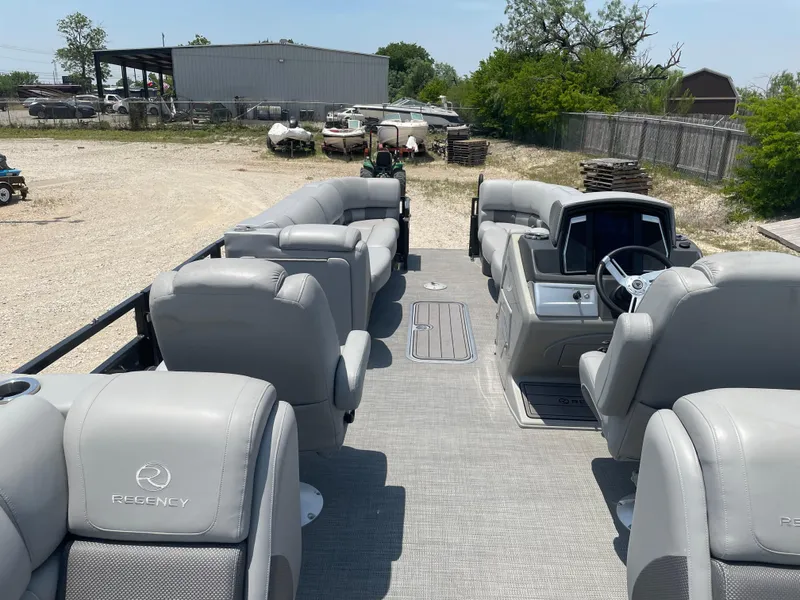 Slide: The Image of 2023 Regency 250 LE3 pontoon boat with spacious seating and modern design. - 17